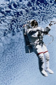 Picture showing an astronaut floating in space above Earth